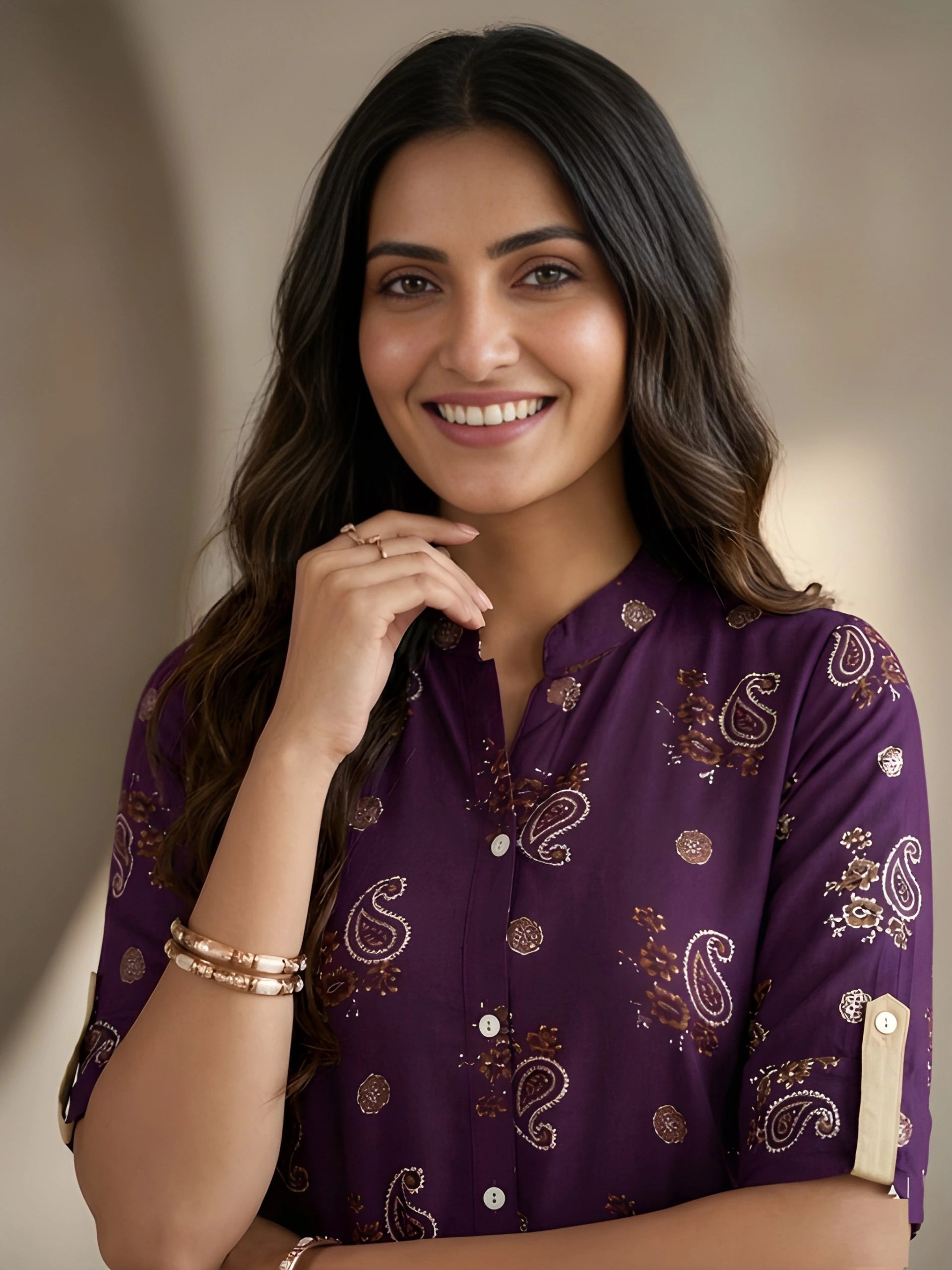 Woman wearing a purple patterned shirt with a blurred background